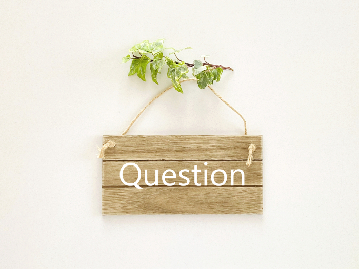 Wooden nameplate with Question lettering and ivy