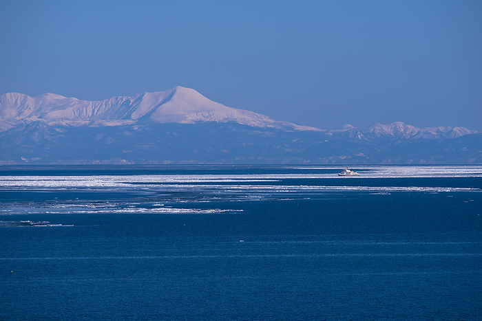 Icebreaking Sightseeing Boat and Shiretoko Mountain Range