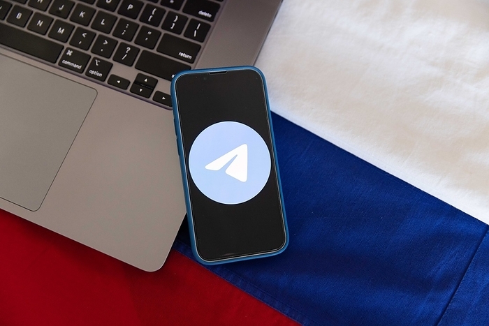 Telegram Messenger App logo with Russian flag. Illustration showing Telegram Messenger App logo displayed on a mobile phone together with the colors of the Russian flag. February 1, 2023.  Photo by Stanislav Kogiku AFLO 