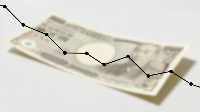 Image of a blurred 10,000-yen bill and a rightward-falling line chart_tanned wide