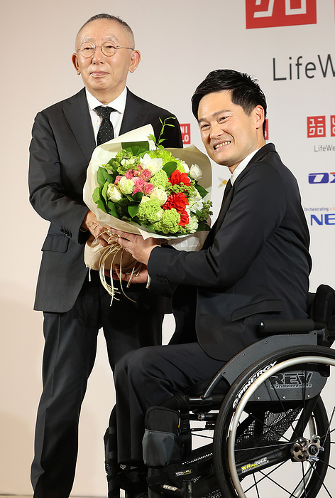 Japan s professional wheelchair tennis player Shingo Kunieda announces his retirement from professional carrier February 7, 2023, Tokyo, Japan   Japan s professional wheelchair tennis king Shingo Kunieda  R  who won the total 50 Grand Slam titles and 4 Paralympic gold medals receives a flower bouquet from fast fashion giant Uniqlo president Tadashi Yanai  L  as Kunieda announced his retirement from professional wheelchair tennis carrier at the Uniqlo headquarters in Tokyo on Tuesday, February 7, 2023. Kunieda is a global ambassador of the Uniqlo.    Photo by Yoshio Tsunoda AFLO 