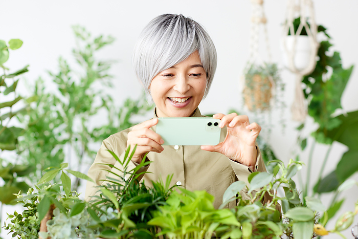 Japanese woman taking a picture with her smartphone