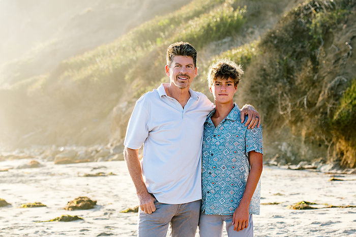 Portrait Of Father And Teen Sun At The Beach During Golden Hour