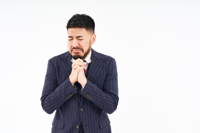 Man in suit in praying pose