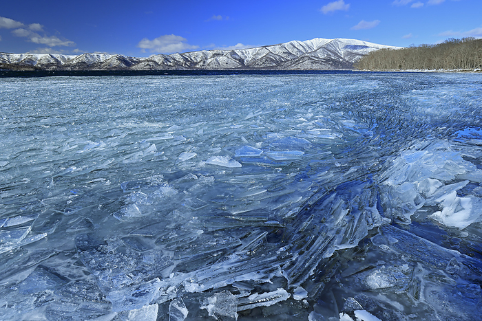 Ice on the shore of Lake Kussharo and Mt.