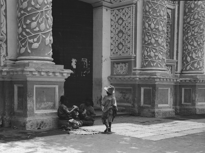 Travel views of Cuba and Guatemala, between 1899 and 1926. Creator: Arnold Genthe. Travel views of Cuba and Guatemala, between 1899 and 1926. Women and children outside a church with ornate plasterwork decoration. Creator: Arnold Genthe.