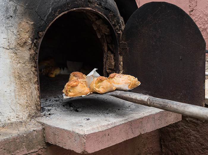 Cooked Cypriot Easter cheese pies Flaounes on a clay oven . Cyprus