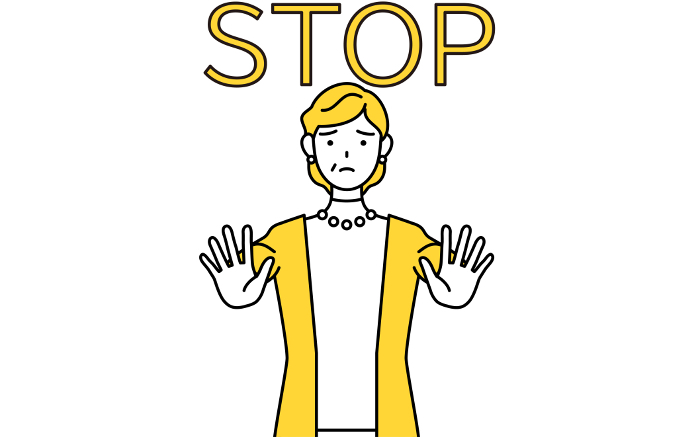 Signal to stop, retired senior/middle-aged woman with hands out in front of her body.