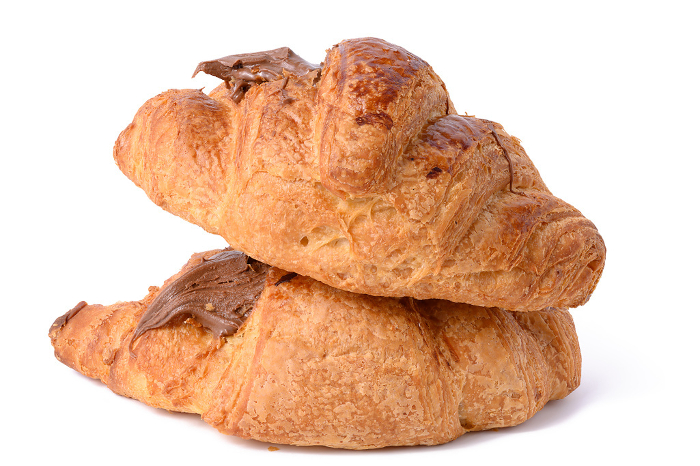 A baked chocolate croissant on a white isolated background, a delicious dessert and breakfast A baked chocolate croissant on a white isolated background, a delicious dessert and breakfast