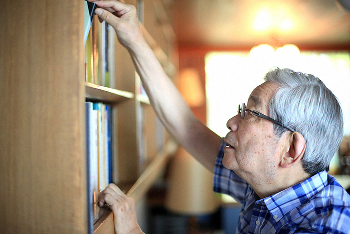 Author Kenzaburo Oe Kenzaburo Oe taking a book from the bookshelf in Setagaya ku, Tokyo, July 30, 2012  photo by Naosho Umemura.