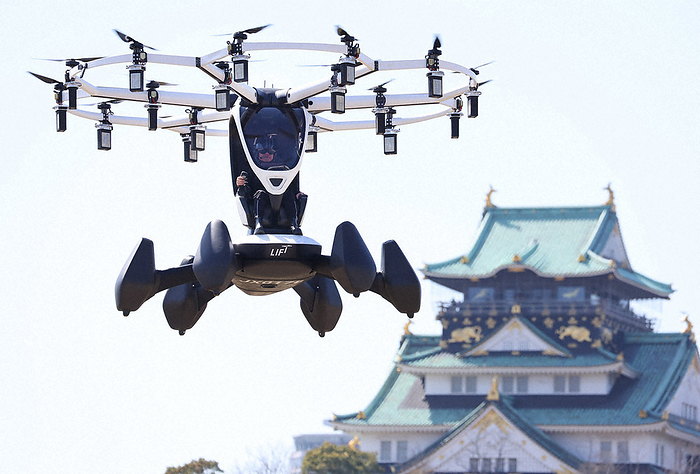 Flying car manned with Osaka Castle in the background A flying car manned with Osaka Castle in the background, March 14, 2023, 1:38 p.m., in Chuo ku, Osaka  photo by Maiko Umeda.