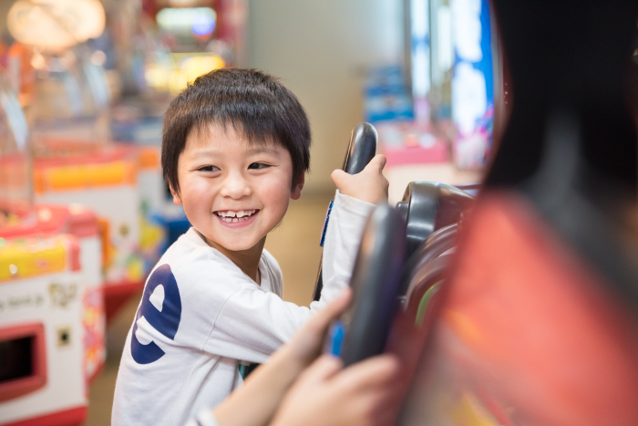 A boy playing in a game arcade