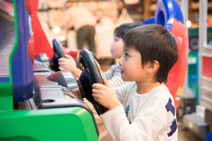 A child playing in a game arcade