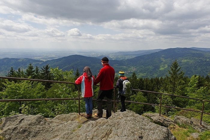 Hikers enjoying the view of the Danube plain from Kreuzfelsen peak, Dreitannenriegel mountain, near Grafling, Bavarian Forest, Bavaria, Lower Bavaria, Germany, Europe