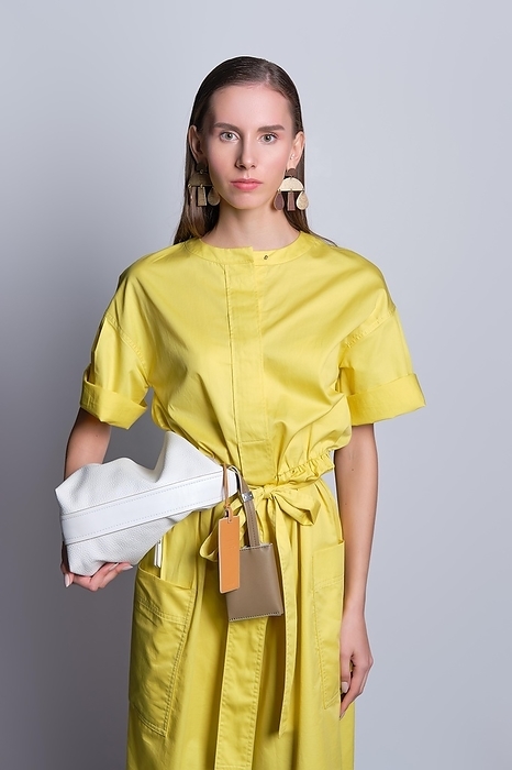 Cute girl in yellow dress with handbag