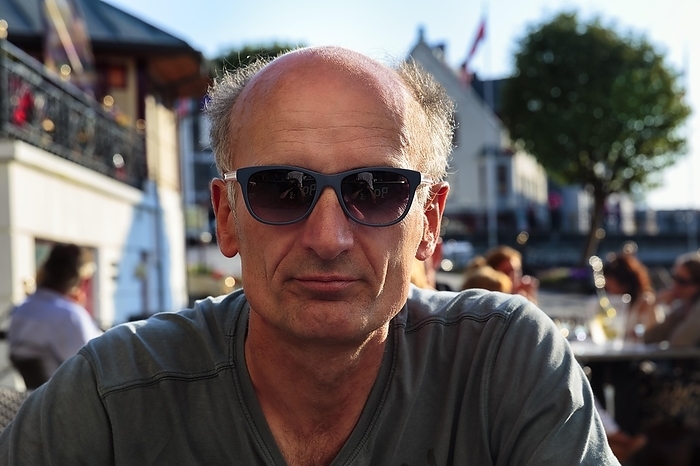 Best Ager, portrait with sunglasses, casual, unshaven, sitting in beer garden, Norway, Europe