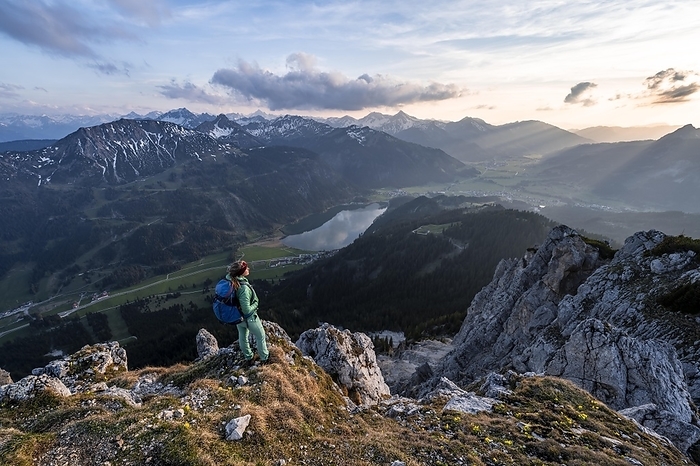 Evening atmosphere, mountaineer at the summit of Schartschrofen looking down on Haldensee, Tannheimer Bergen, Allgecumenical Alps, Tyrol, Austria, Europe