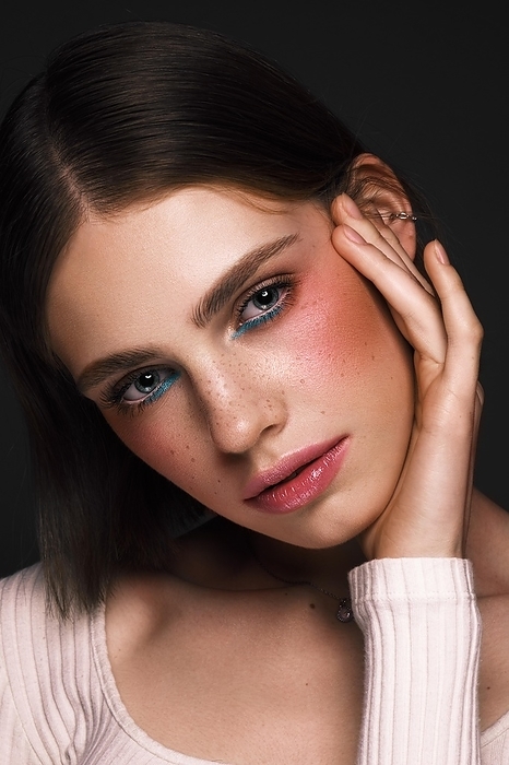 Beautiful girl with creative colorful makeup. Beauty face. Photos shot in studio