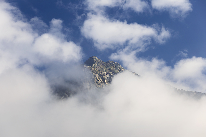 Italy Clouds surround Cima Giner, Nambrone valley  val Nambrone , Trento province, Trentino Alto Adige, Italy, Europe. Photo by: Alessio Giovacchini
