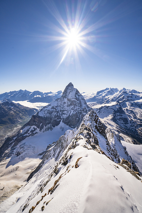 Italy Alps landscape from the summit of Dent d Herens peak. With the snow ridge of the summit and north face of Matterhorn in the background. Valpelline valley, Bionaz, Aosta Valley, Alps, Italy, Europe.. Photo by: Giacomo Meneghello