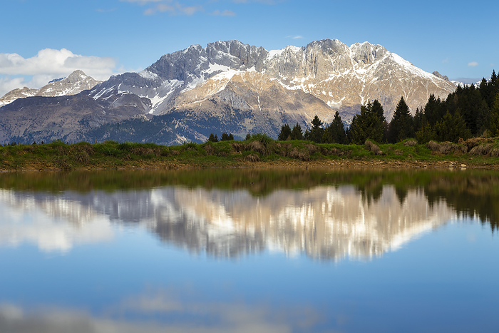 Italy View of the Presolana mountain reflected on a spring pond on Monte Pora. Songavazzo, Val Seriana, Bergamo district, Lombardy, Italy, Southern Europe.. Photo by: Mirko Costantini