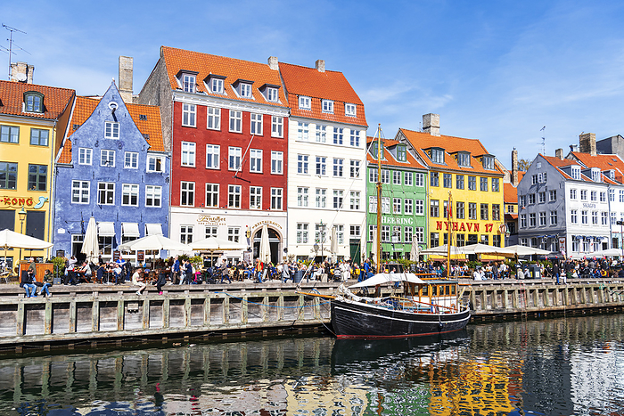 Copenhagen, Denmark View of the colourful buildings and an old ship along Nyhavn canal with reflection in the water, Copenhagen, Hovedstaden Denmark, Europe. Photo by: Paolo Graziosi