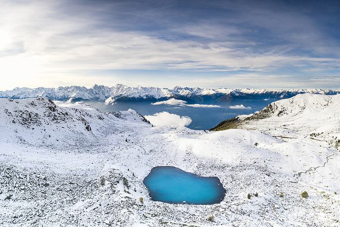 Italy Aerial view of the Orobie Alps mountain range covered with snow and frozen Rogneda lake, Rhaetian Alps, Lombardy, Italy. Photo by: Roberto Moiola