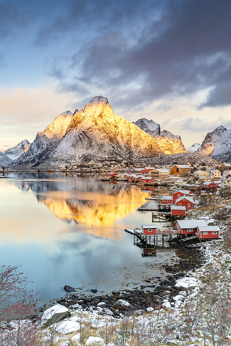 Lofoten Islands Snowcapped mountains reflected in the cold sea at sunrise, Reine Bay, Nordland county, Lofoten Islands, Norway. Photo by: Roberto Moiola