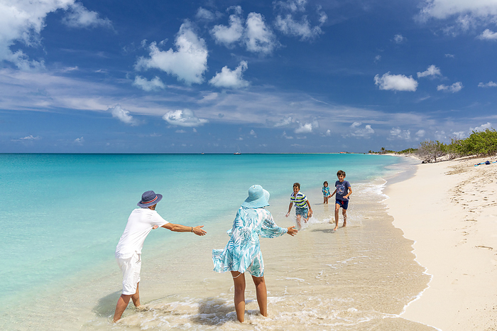 Antigua and Barbuda Barbuda Happy family with three kids playing on a tropical beach in summer, Barbuda, Antigua   Barbuda, Caribbean, West Indies. Photo by: Roberto Moiola