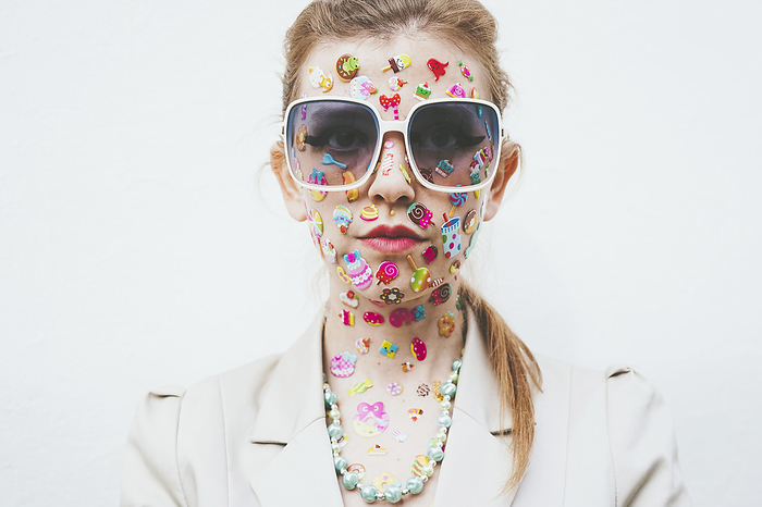 Woman with colorful stickers in front of white background