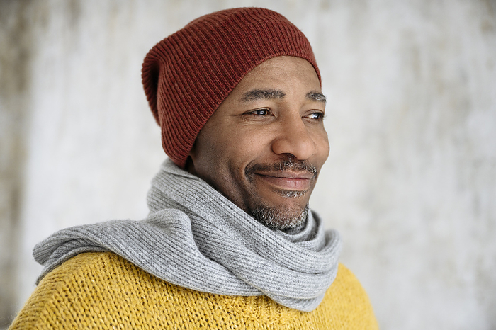 Smiling man wearing scarf and knit hat