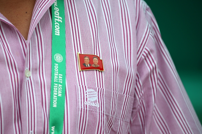 East Asia Cup 2013 Kim Kwang Min  PRK , JULY 27, 2013   Football   Soccer : A badge of Kim Il Sung and Kim Jong Il on DPRK s headcoach Kim Kwang Min s shirt during the EAFF Women s East Asian Cup 2013 match between North Korea 1 0 China at the Seoul Jamsil Olympic Stadium in Seoul, South Korea.   Photo by Jun Tsukida AFLO SPORT   4061 