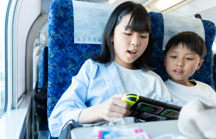 Girl and boy playing a game on a train