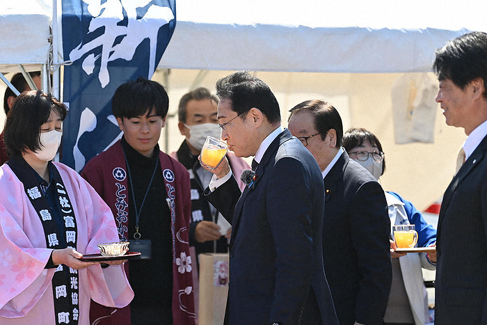 Prime Minister Kishida Visits Fukushima Prefecture Prime Minister Fumio Kishida drinks passion fruit juice, a new specialty product, after attending a commemorative ceremony in Tomioka Town, Fukushima Prefecture, where the evacuation order has been lifted in part of the hard to return zone, on April 1, 2023  Representative photo 