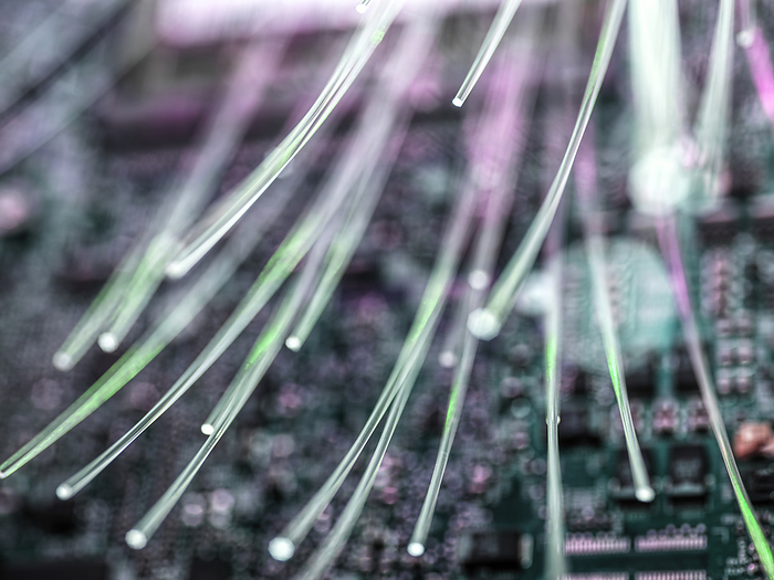 Close-up of fibre optics carrying data being transferred to desk top computer