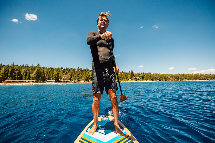 USA, California, Man paddleboarding on Lake Tahoe