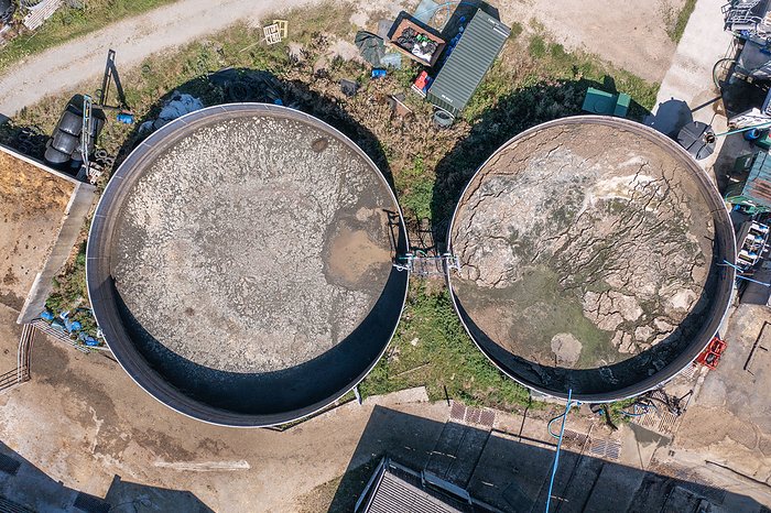 Slurry tanks on a farm, aerial photograph Aerial photograph of a farm showing slurry tanks. Slurries are formed of water and cow manure, and are used as natural fertilisers to encourage the growth of crops. Photographed in Towy Valley, Carmarthenshire, Wales, UK, Europe., by ANDY DAVIES SCIENCE PHOTO LIBRARY
