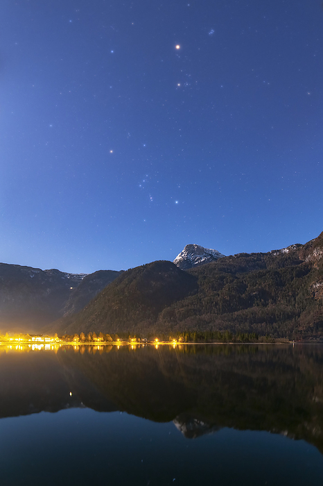 Mars and winter constellations over Lake Hallstatt, Austria Mars and the stars of the Orion and Taurus constellations shining over Lake Hallstatt, Austria. Moonlight has illuminated the scene and cast a blue colour on the sky., by AMIRREZA KAMKAR   SCIENCE PHOTO LIBRARY