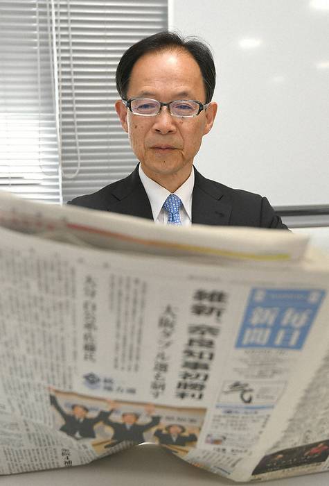 2023 Local elections, first half of the year, one night after the date of the vote Juichiro Sato looks through newspapers after winning the gubernatorial election, 9:53 a.m., April 10, 2023, in Oita City, Japan.