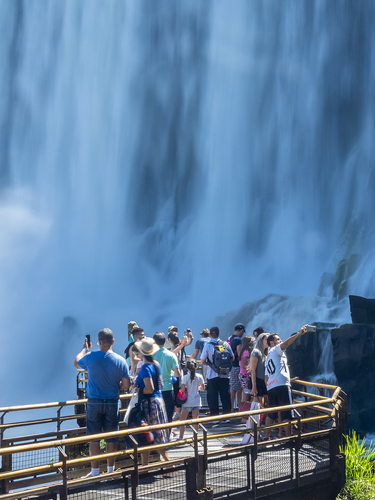 Tourists on a platform on the lower circuit at Iguaz  Falls, Misiones Province, Argentina. Tourists on a platform on the lower circuit at Iguazu Falls, UNESCO World Heritage Site, Misiones Province, Argentina, South America, by Michael Nolan