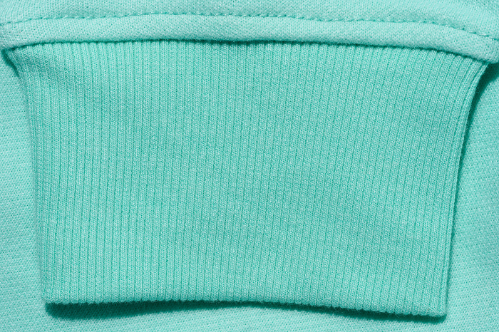 Mint cotton sweater sleeve, close up Mint cotton sweater sleeve, close up