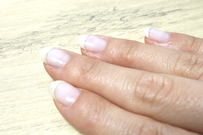 Close-up of a woman's nails with clear nail polish