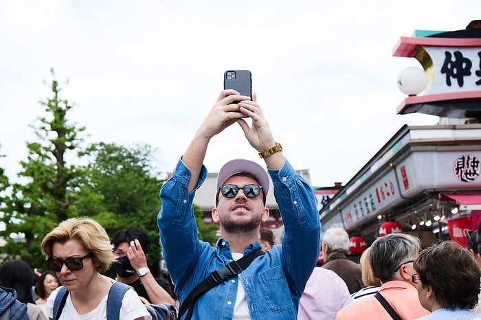 Spring vacation week in Japan A foreign tourist takes picture at Nakamise shopping street, an approach to the Sensoji temple in Asakusa entertainment district, Tokyo in Japan on May 1, 2023.  Yohei Osada AFLO 