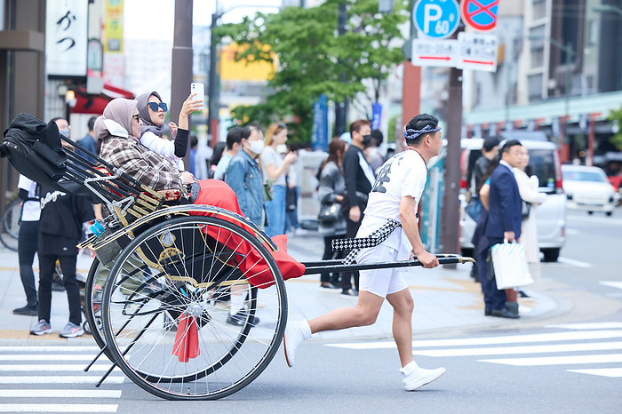 2023 Golden Week New Corona waterfront measures lifted A rickshaw puller carries foreign tourists near Nakamise shopping street, an approach to the Sensoji temple in Asakusa entertainment district, Tokyo in Japan on May 1, 2023.  Yohei Osada AFLO 