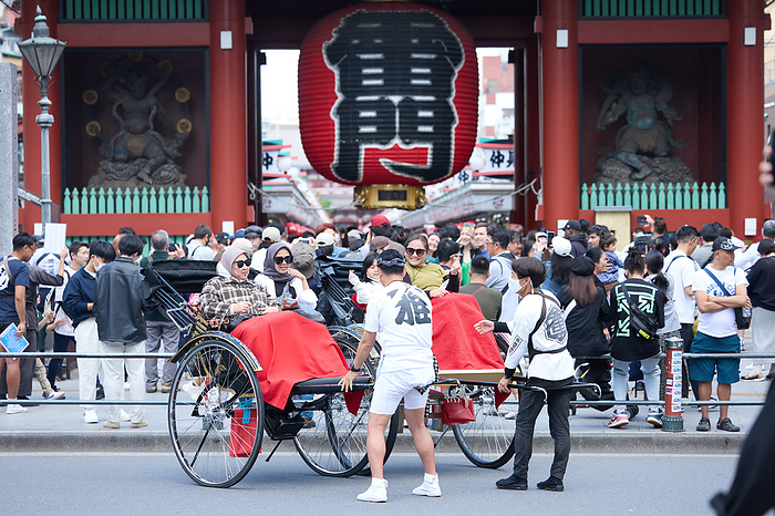2023 Golden Week New Corona waterfront measures lifted A rickshaw puller carries foreign tourists at Nakamise shopping street, an approach to the Sensoji temple in Asakusa entertainment district, Tokyo in Japan on May 1, 2023.  Yohei Osada AFLO 