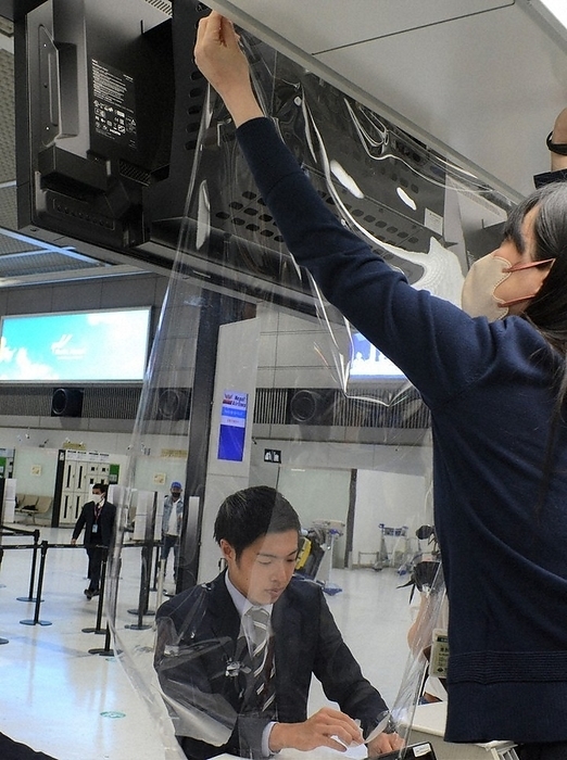 New Corona moves to Class 5. Staff members of Narita International Airport Company remove transparent anti splash film at Narita Airport in Narita City, Japan, at 9:34 a.m. on May 8, 2023.