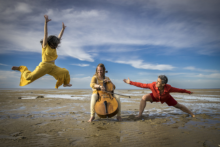 dancers and cellist performing on Cape Cod beach