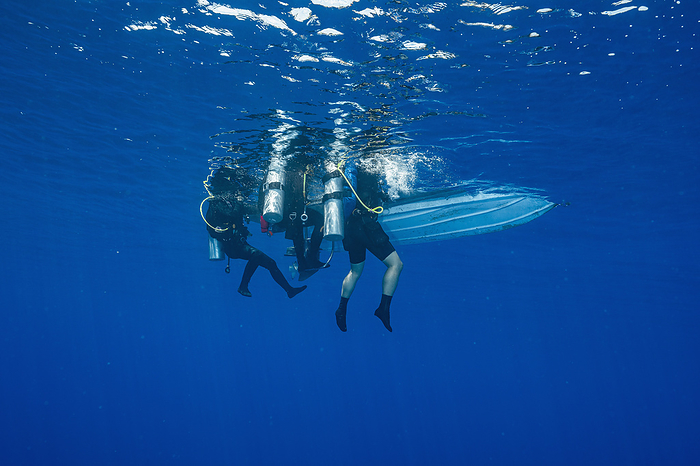 divers floating next to a dinghy in the Banda Sea