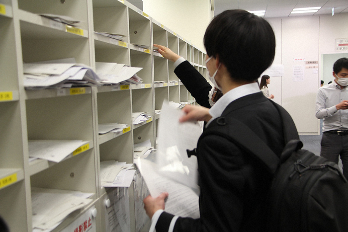 Company representatives posting materials for the press as earnings announcements reach their peak. Company representatives post materials for the press as earnings announcements reach their peak at the Tokyo Stock Exchange in Chuo ku, Tokyo, at 3:09 p.m. on May 12, 2023.