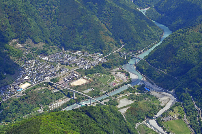 Central area of Goki Village, which is scheduled to be submerged due to the construction of the Kawabe River Dam The central area of Goki Village, which is scheduled to be submerged due to the construction of the Kawabe River Dam. On the left is Touji village, which was relocated to higher ground due to the dam project. The Kawabe River flows from the lower left  upstream  to the upper right.